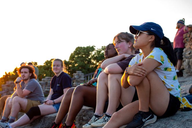 A group of Honors Advance students watch the sun set at Cooper's Rock